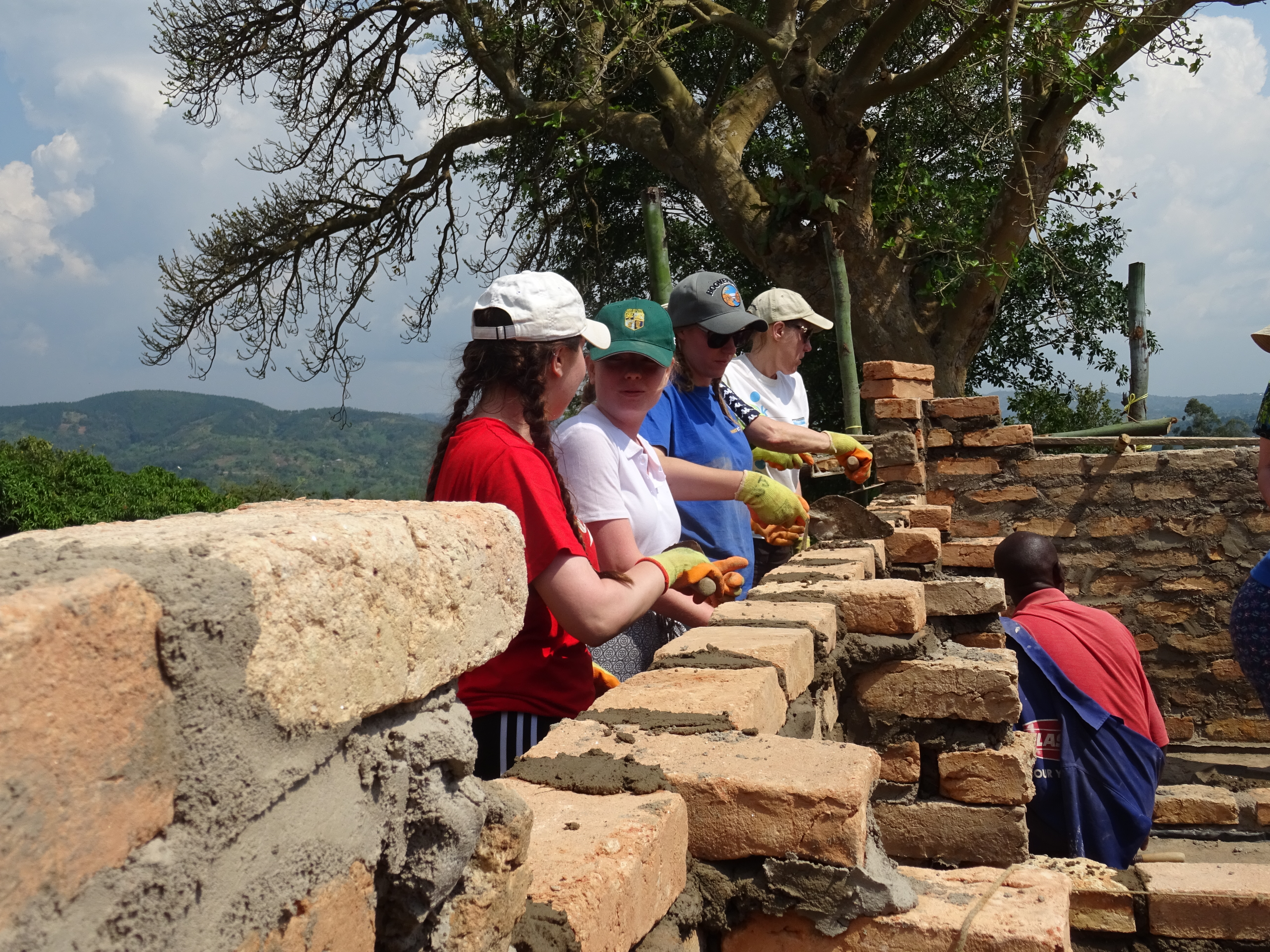 Volunteers helping with bricklaying at Rushararazi school Uganda